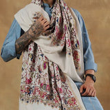 Person wearing a patterned scarf with a plain background