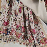 Person wearing a patterned scarf with a plain background