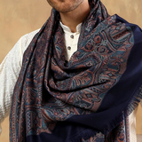 Man wearing a patterned scarf with a neutral background