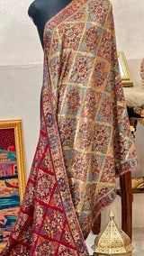 Colorful patterned scarf on a mannequin with a decorative background