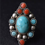 Handmade Tibetan coral and turquoise statement ring with detailed silverwork